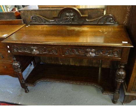 Victorian oak ornately carved two tier buffet with carved mask head mounts. (B.P. 21% + VAT)  W122xH97xD50cm approx.  The dam
