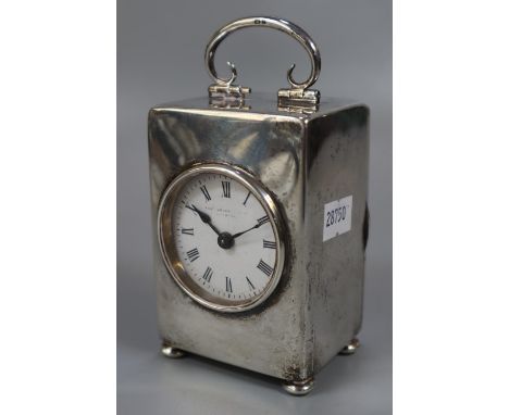 Early 20th century silver cased carriage clock, the face marked Rob Jones? with back winding movement standing on bun feet.  