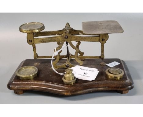 Set of 19th century brass letter scales and weights on serpentine shaped mahogany base.   (B.P. 21% + VAT) 
