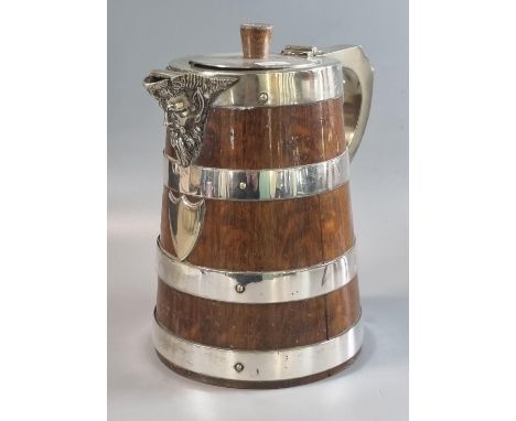 Early 20th century oak and silver plated coopered tapering single handled jug with mask head spout.  24cm high approx.   (B.P
