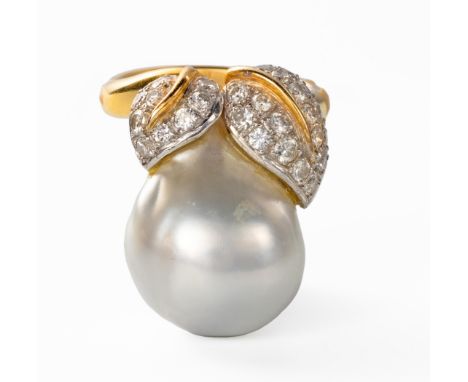 Centred with a baroque pearl, approximately 18,5mm in length, embellished with two stylised leaves, pavÃ© set with round bril