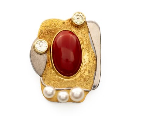 Of abstract design, centred with an oval cabochon orange-red coral measuring approximately 23,5 by 15mm, bezel set with two r