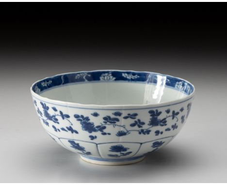 The moulded bowl painted to the central well with a roundel containing flowering branches, the exterior with ten shaped carto