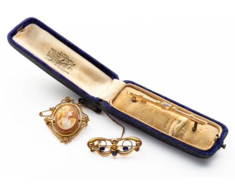 Comprising: an oval cameo brooch, a garnet and seed pearl bar brooch, and a blue gem, possibly paste, brooch, distress, repai