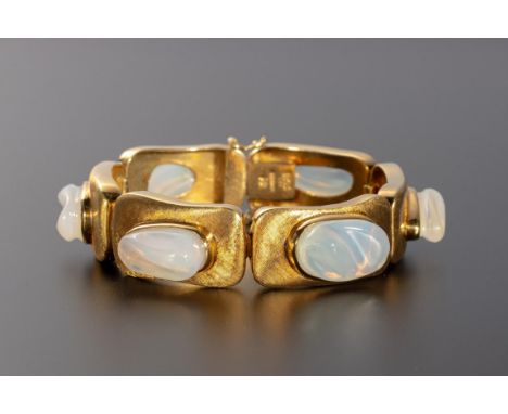 Designed as a series of six undulating links with textured finish, each bezel set to the centre with a fancy-cut moonstone, s