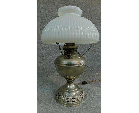 A vintage oil lamp with original milk glass shade. H.44cm 