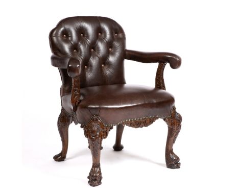 AN 18TH CENTURY STYLE OAK OPEN ARM LIBRARY CHAIR upholstered in button brown leather and on ornately carved cabriole legs wit