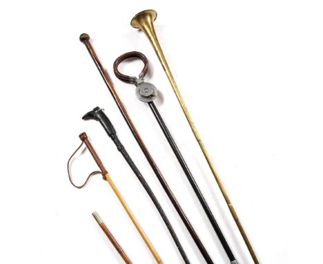 A LIGNUM VITAE STAFF with knob handle 155cm high, a novelty riding whip with riding boot and spur handle, two other riding wh
