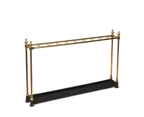 A VICTORIAN BRASS TEN SECTION STICK STAND with turned finials and black painted metal drip tray base, 103cm long 