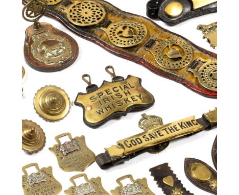 A COLLECTION OF 19TH AND 20TH CENTURY HORSE BRASSES, comprising two sets of tasselled harness bells, various swing fly terret