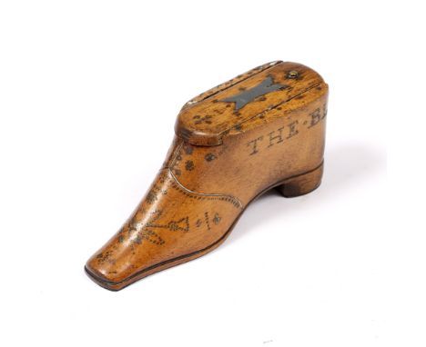 A 19TH CENTURY TREEN SNUFF BOX IN THE FORM OF A SHOE, with sliding lid, having studded metal decoration and inscription 'The 