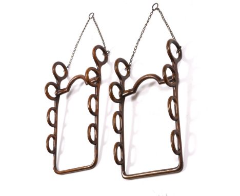 TWO LATE 19TH/EARLY 20TH CENTURY OAK HUNTING/COACHING WHIP WALL RACKS each modelled as a horse's bit with ported mouthpiece a
