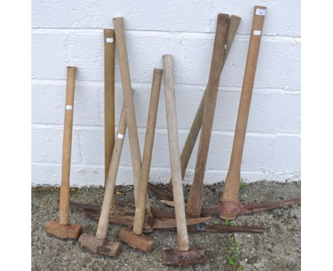 A collection of tools comprising four sledge hammers and five picks