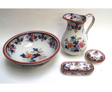 A late 19th century pottery wash jug and basin, decorated in underglaze blue, printed and painted in coloured enamels