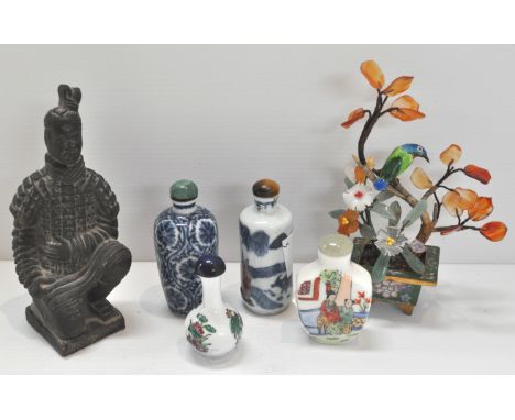 A hardstone enamel tree, four scent bottles and a black stoneware figure