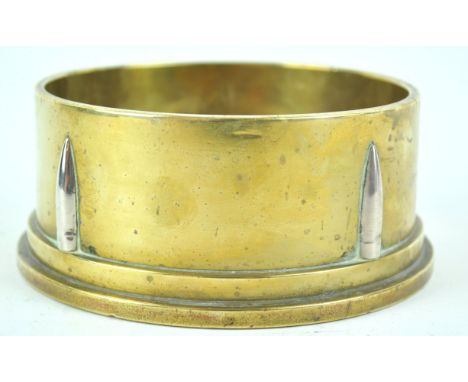 A 1942 trench art ashtray, constructed from the base of a shell case with bullet head decoration, 13cm diameter