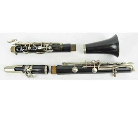 A cased Boosey &amp; Hawkes clarinet, together with a small collection of sheet music
