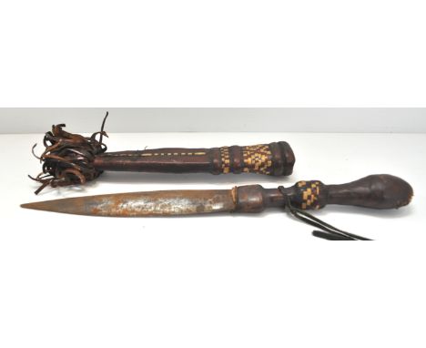 An early 20th century Sudanese dagger having leather and grass decorated hilt and scabbard, 31cm