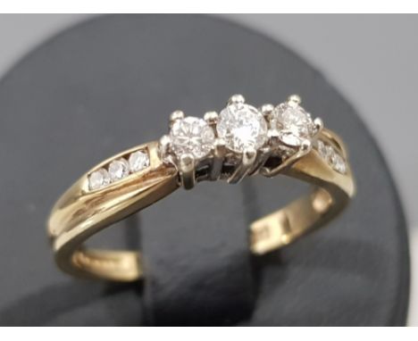 Ladies 9ct yellow gold diamond ring with 3 round brilliant cut diamonds in the centre and 3 more on each shoulder, apx. 25ct,