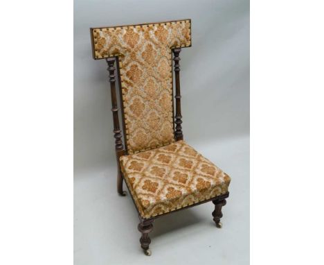 A 19TH CENTURY HIGH BACKED NURSING CHAIR / PRIE-DIEU, having turned and reeded pilaster supports, with flock upholstered back