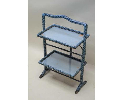 A RETRO DESIGNED METAMORPHIC FIRESCREEN / CAKE STAND, finished in blue and black rattan, with glass tray tops, 82cm high 