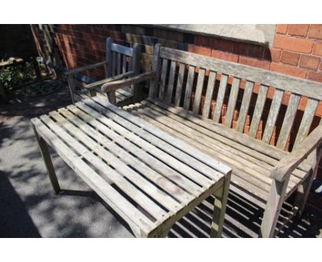 THREE PIECES OF WELL-WEATHERED TEAK SLAT BUILT GARDEN FURNITURE comprising; one three-person bench, one single armchair and a