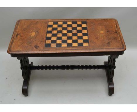 A 19TH CENTURY INLAID CENTRE TABLE with central chess board, flanked by two floral swags, supported on low carved and pierced