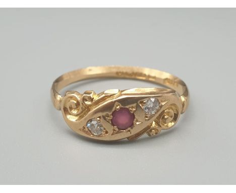 An 18K Yellow Gold Diamond and Ruby Three Stone Ring. Size O. 2g 