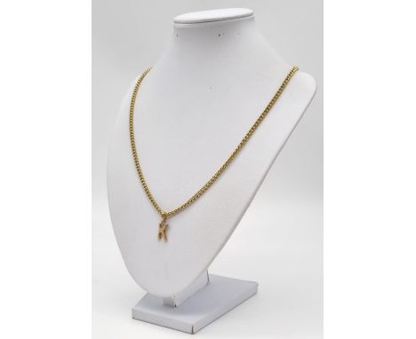 A 9k Yellow Gold Letter K Pendant. 1.51g. Comes with a long yellow metal chain necklace. 66cm 
