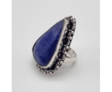 A large pear shaped statement ring featuring a deep colour blue agate stone. Size P 