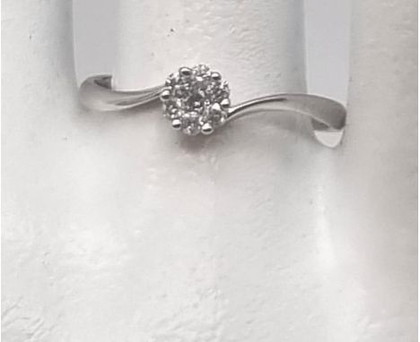 9K WHITE GOLD RING WITH A .75 DIAMOND.  1.3gms  size Q 