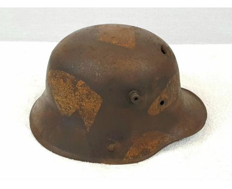 Relic WW1 Imperial German Stahlhelm Helmet. with a bullet hole and the remains of jigsaw patterncamouflage. Found in a cellar