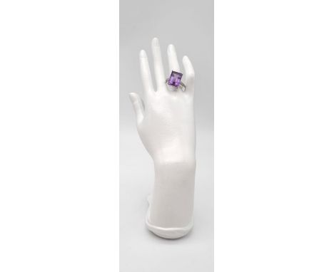 A gents sterling silver ring with a large amethyst 25 carats and 0.25 carats diamonds on shoulders. Ring size: U. weight: 10 