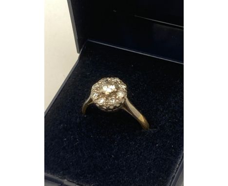 DIAMOND CLUSTER RING set in 18 carat GOLD and PLATINUM. 0.65 carats .3.25 grams. Size N- N 1/2. 