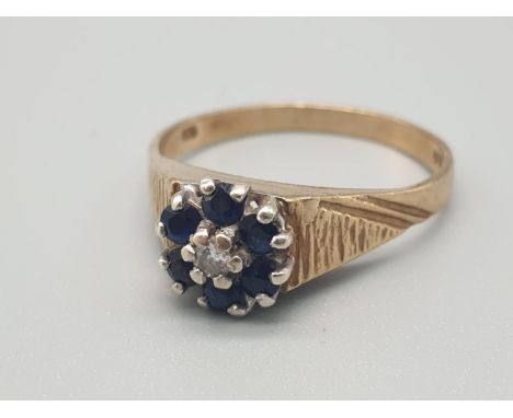 A 9K GOLD SAPPHIRE AND DIAMOND RING.  2.1gms   size M 