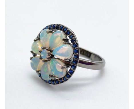 An Opal and Blue Sapphire Silver Ring. 4.7ct Opal. 0.85ct Sapphire. Size R. 6g 