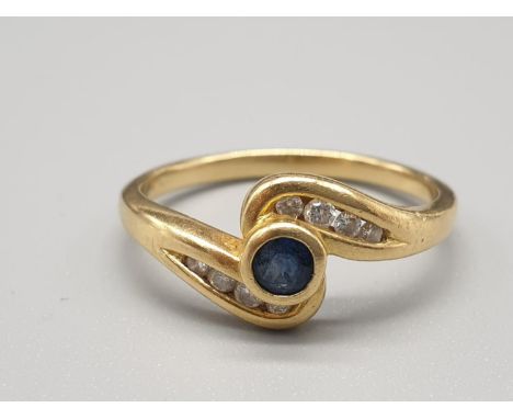 18CT YELLOW GOLD DIAMOND &amp; SAPPHIRE TWIST RING IT HAS  0.10CT, WIEGHS 4G AND IS A SIZE Q 