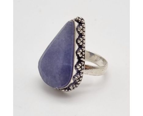 A large pear shaped statement ring in silver featuring a matt blue/grey stone. Size P. 