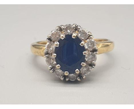 An 18K Yellow Gold Diamond and Sapphire Cluster Ring.Size K. 0.3ct. 3.8g 