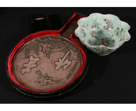 Japanese bronze hand mirror and lacquered case and a Chinese celadon fluted dish with insect and floral decoration, 27cm and 