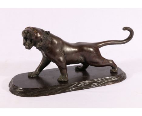 Japanese bronze model of a tiger with inset glass eyes, wooden base, signed to base, Meiji / Taisho, 41.5cm.