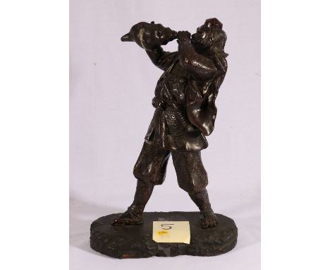 Large Japanese bronze figure of a man blowing a conch shell, wearing traditional dress, wooden base, Meiji, 40.5cm CONDITION 