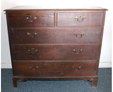 19th century oak chest of drawers, the rectangular top with moulded edge, over two short and three long graduated drawers, ra