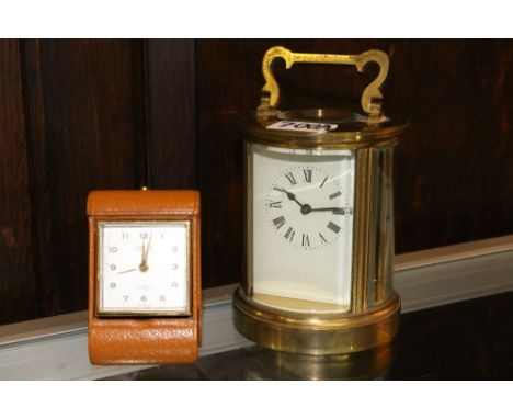 French cylindrical brass carriage clock, the back plate stamped ACG and a Looping 8 day folding travelling alarm clock with 1