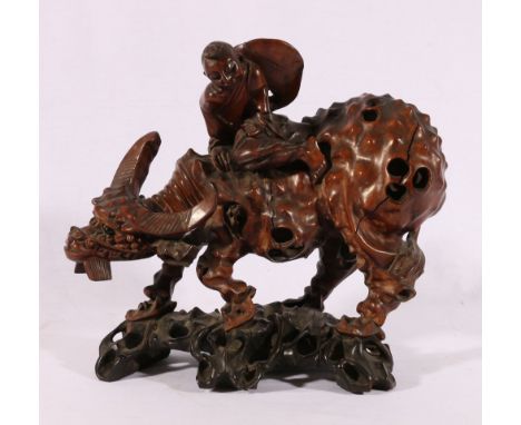 Large Chinese carved rootwood model of an ox with a boy riding on his back, naturalistic base, inset glass eyes.