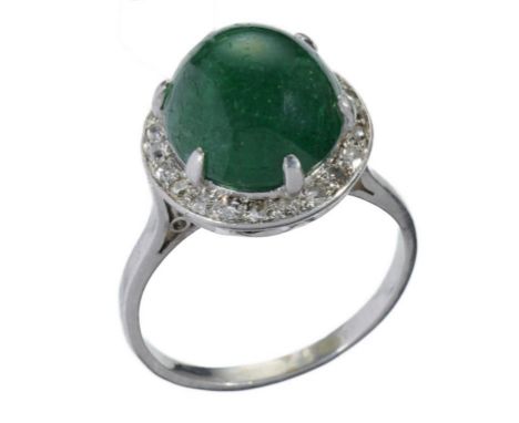 A CABOCHON EMERALD AND DIAMOND CLUSTER RING in platinum coloured metal, 6.7g, size N++The emerald retaining mostly good polis