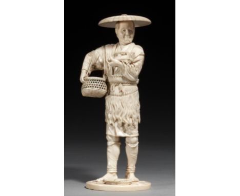 A TOKYO SCHOOL IVORY OKIMONO OF A FISHERMAN, MEIJI PERIOD carrying a basket and holding a crayfish in his left hand, 27cm h, 