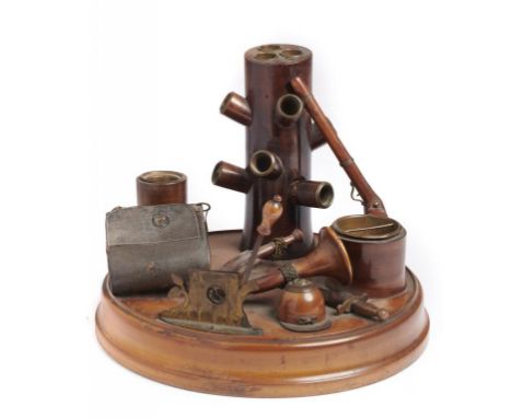 A BRASS MOUNTED LIGHT WOOD SPORTSMAN'S SMOKING COMPANION  the round base with brass lever cigar cutter, French  horn rustic s
