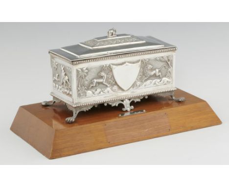 AN INDIAN SILVER CASKET, EARLY 20TH C  the stepped rectangular lid with elephant knop, the sides with repoussé panels of Indi