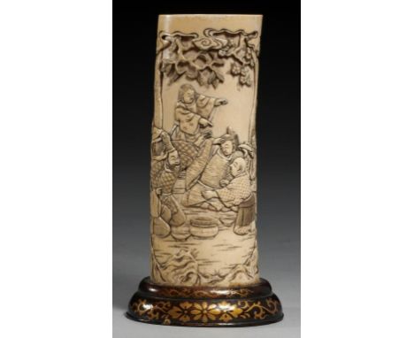 A JAPANESE IVORY VASE, MEIJI PERIOD carved from a section of tusk with a continuous scene with seated or kneeling figures bet